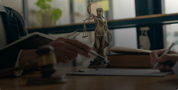 commercial real estate lawyer's desk with gavel and Lady Justice statue in a professional office setting