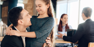 Family in a lawyer's office: father and daughter in a closer frame, and mother and lawyer in the background