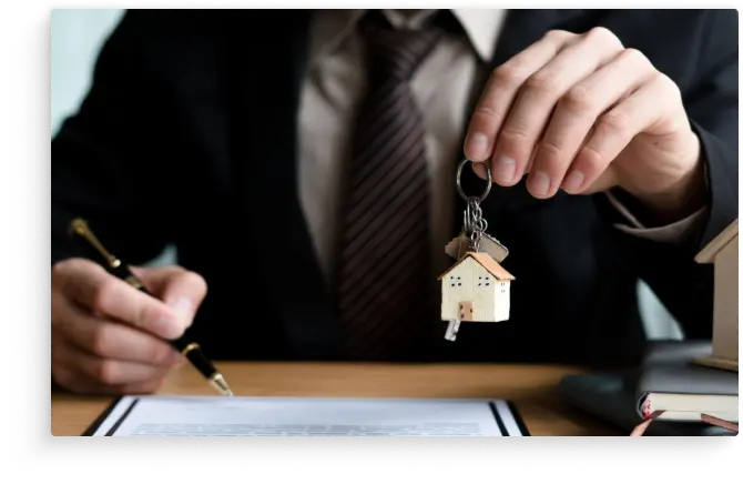  Real Estate lawyer reviewing legal documents and holding a house shaped keychain