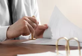 Lawyer and client shacking hands inside a building